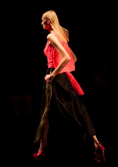 Danny roberberts vibrant picture of a girl in a red pink blouse top and black pants and red heels in Araisara Tokyo Fashion week Spring 2012 Collections