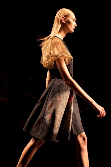 The Profile of a Model in brown yellow and black dress in Araisara Tokyo Fashion week Spring 2012 Collections