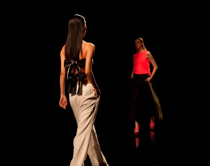 Danny Roberts horizontal picture of two girls walking down the runway girls back with bows on her nude back in Araisara Tokyo Fashion week Spring 2012 Collections