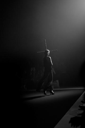 Photographer danny roberts black and white photo of a girl hold a cross in Tokyo Fashion week Designer Christian Dada Spring 2012 collection