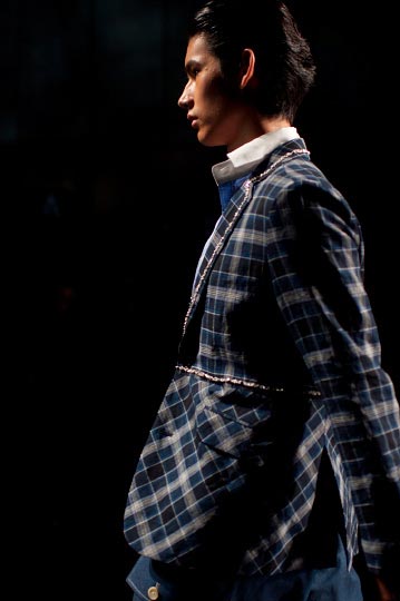 Profil of a male model in a blue ornate jack and blue pants in Keita Maruyama Spring fashion show for tokyo fashion week 2012