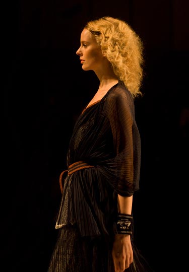 A warm colored photo by danny roberts of a curly haird blond girl in a slightly see through black dress from The Dress Co by designer Kideaki Sakaguchi in the tokyo fashion week spring 2012
